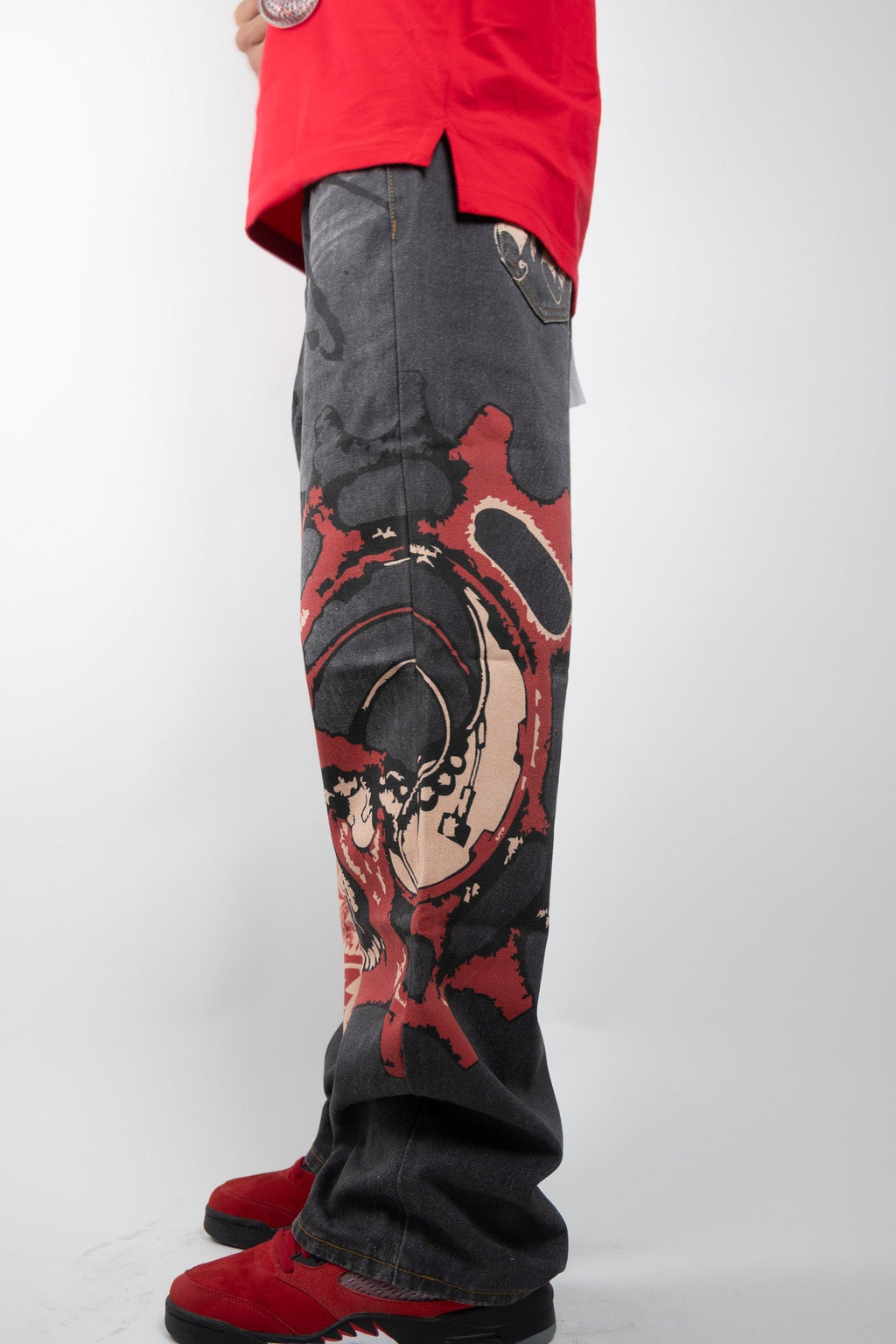 ARMOR JEANS RM200B graphic printed baggy jeans featuring bold patterns and relaxed fit, shown on a hanger.