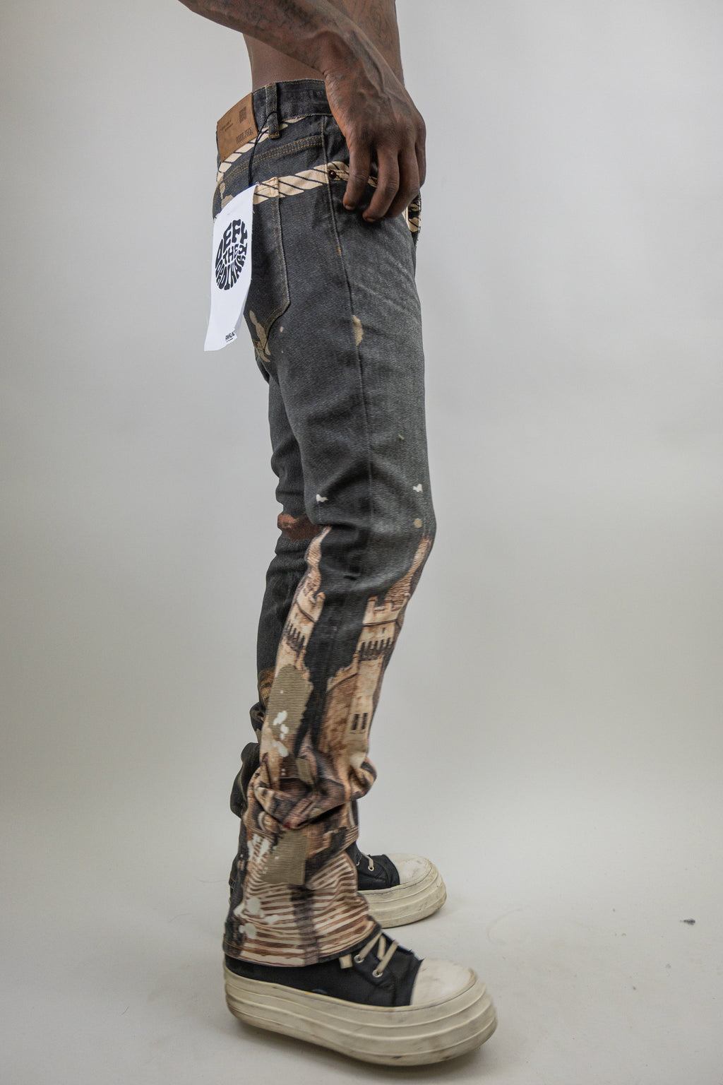 ARMOR JEANS RM203SK graphic printed stacked jeans with bold design, showcased on a model in a casual setting.