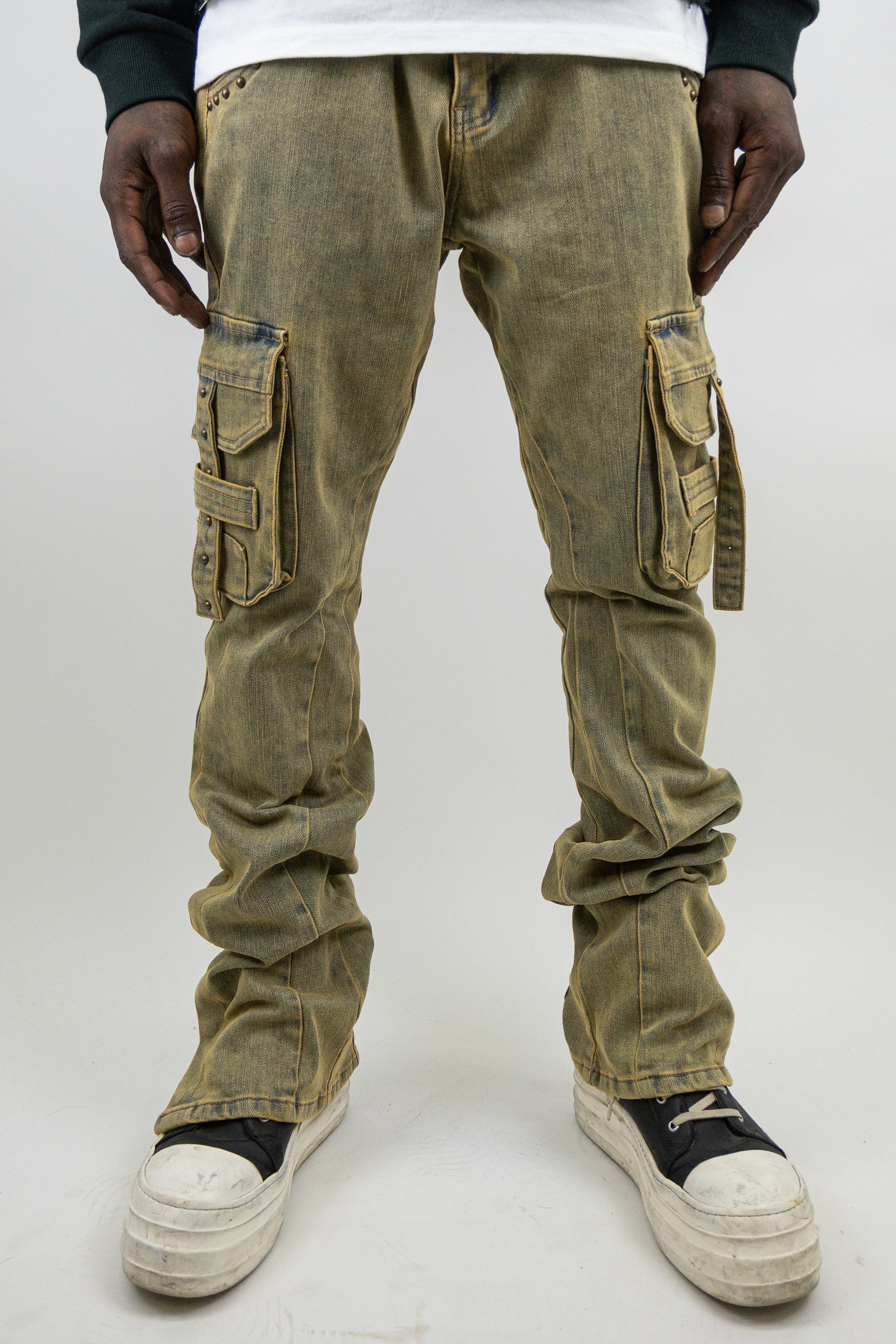 ARMOR JEANS studded stacked cargo jeans with multiple pockets and distressed details, displayed on a hanger.