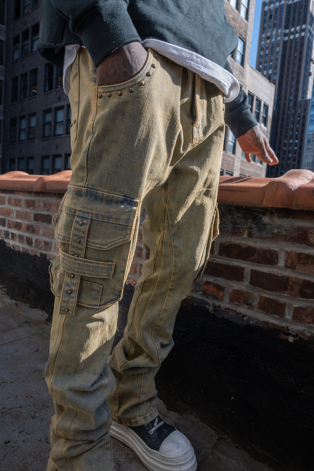 ARMOR JEANS RM207SK studded stacked cargo jeans, showcasing distressed denim with metal stud embellishments and a relaxed fit.