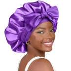 Double-layer satin ribbon hair bonnet with bow, plush fabric sleep cap for hair protection and styling.