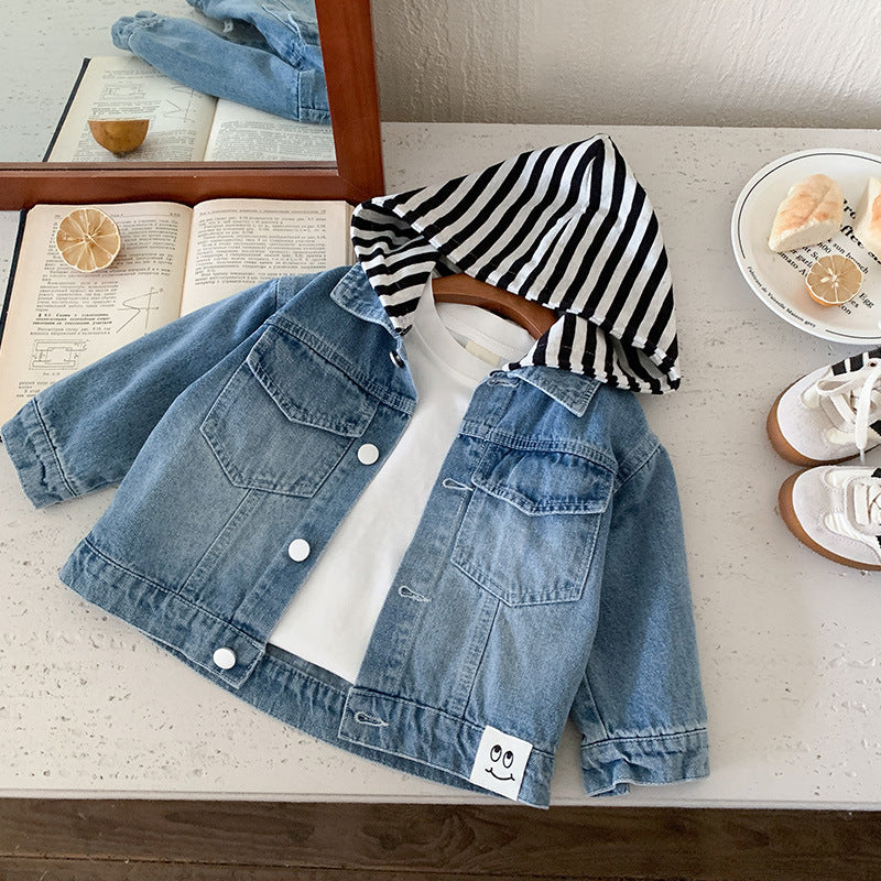 Blue denim jacket with a white and black striped hood, button closure, and chest pockets layered over a white t-shirt.
