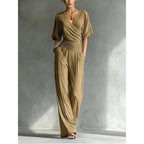 Women's slim fit V-neck jumpsuit with straight leg design by FitiqueFit, shown in a stylish, fitted silhouette.