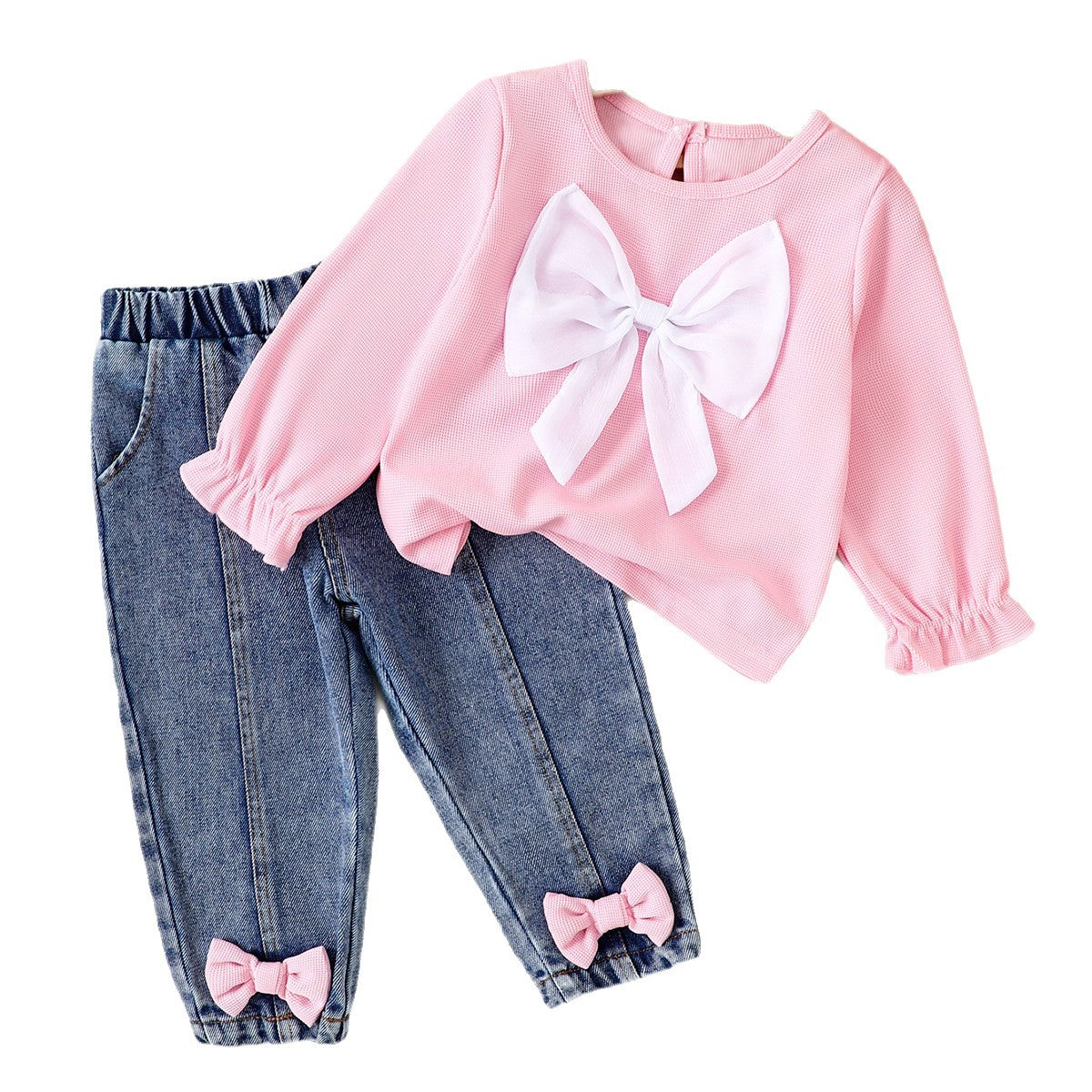 Pink long-sleeve waffle-knit shirt with a large white bow, paired with blue denim pants featuring pink ankle bows.