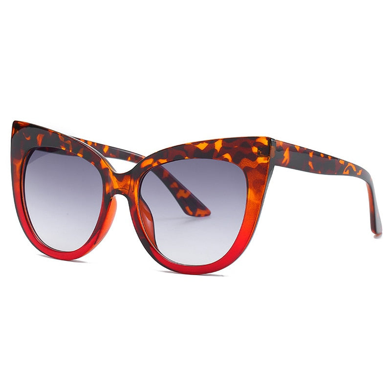 Women's oversized cat eye sunglasses with UV400 protection from Plush Fashion Hub, stylish black frames and tinted lenses.