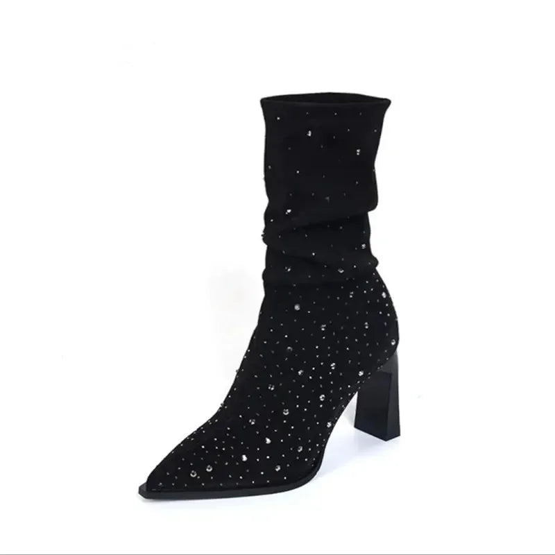 Black suede heeled slouch boot with a pointed toe and rhinestone-studded design.