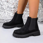 Women's black ankle boots with elastic side panels, slip-on design, and low heel by Plush Fashion Hub.