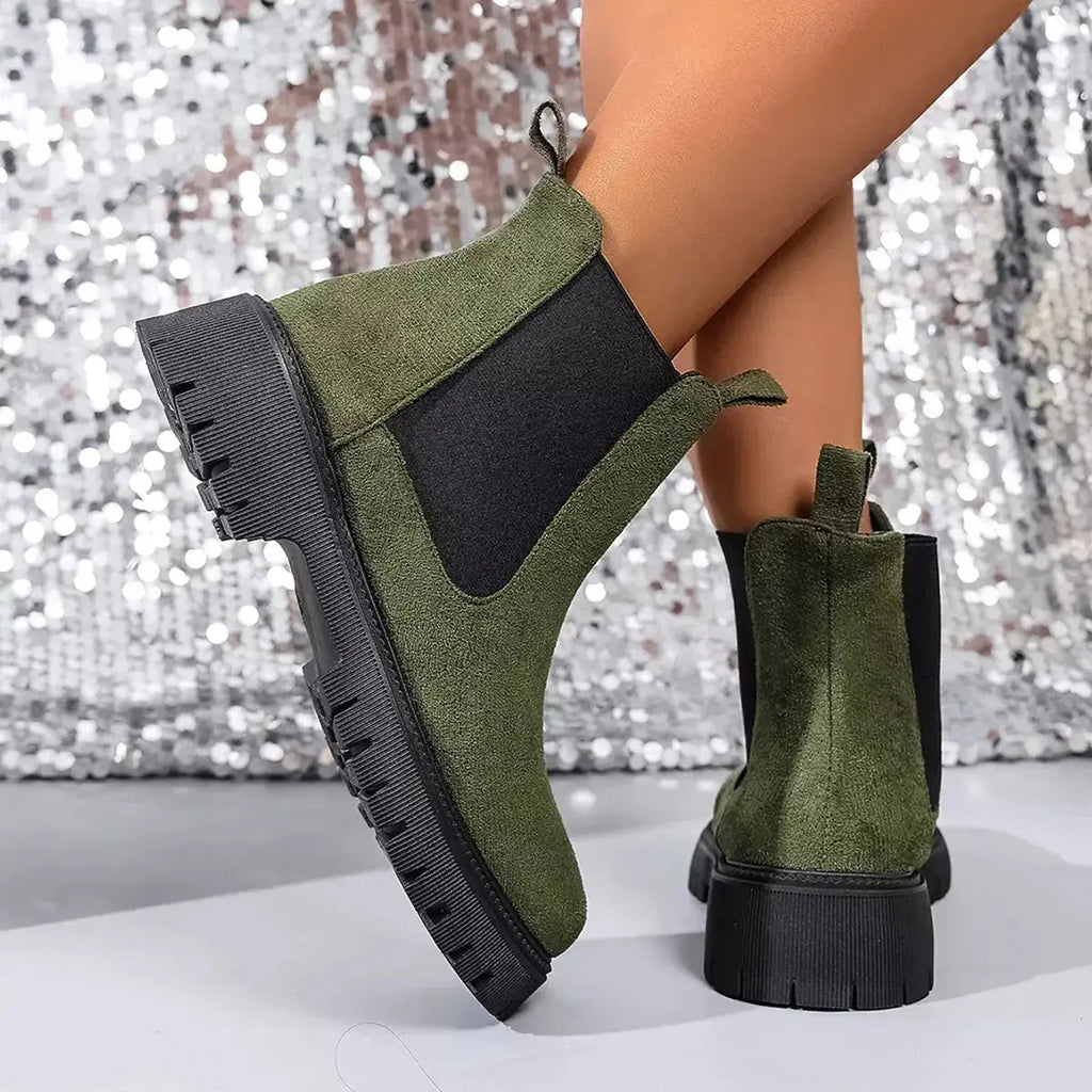 Women's ankle boots with elastic side panels, black slip-on footwear from Plush Fashion Hub featuring a modern, chic design.