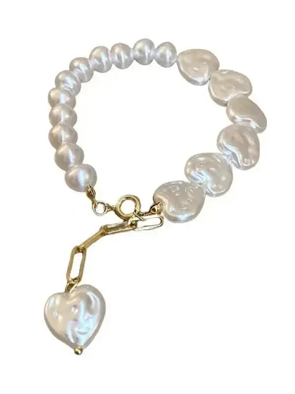 Elegant heart-shaped pearl beaded bracelet with stainless steel clasp from Plush Fashion Hub, perfect for stylish accessories.