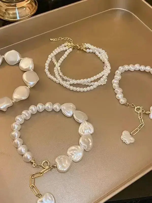Elegant heart-shaped pearl beaded bracelet with stainless steel clasp from Plush Fashion Hub.