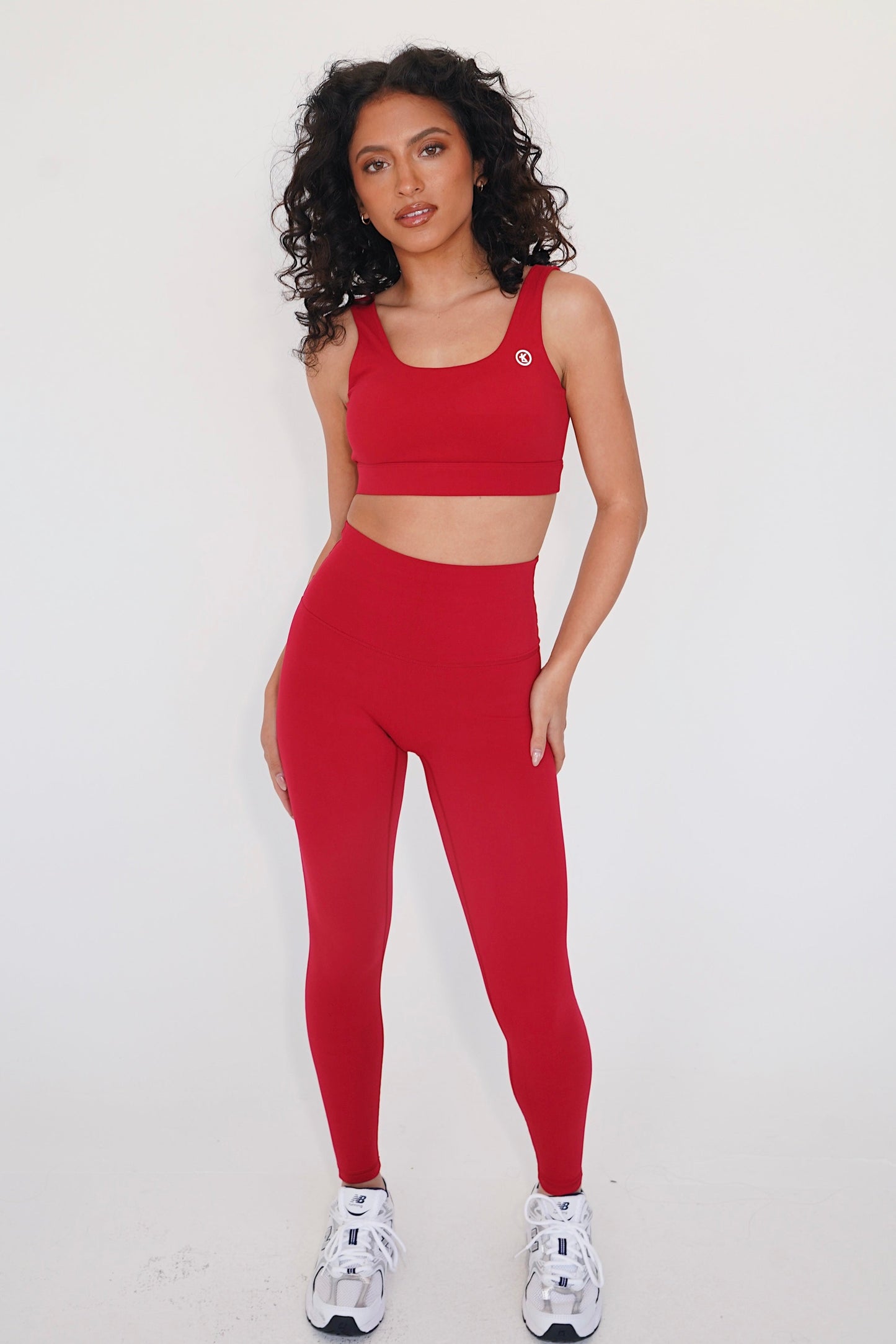 Red yoga legging from Kimith Brand, I am Beautifully Radiant Quick Dry design, shown laid flat to highlight fit and fabric texture.