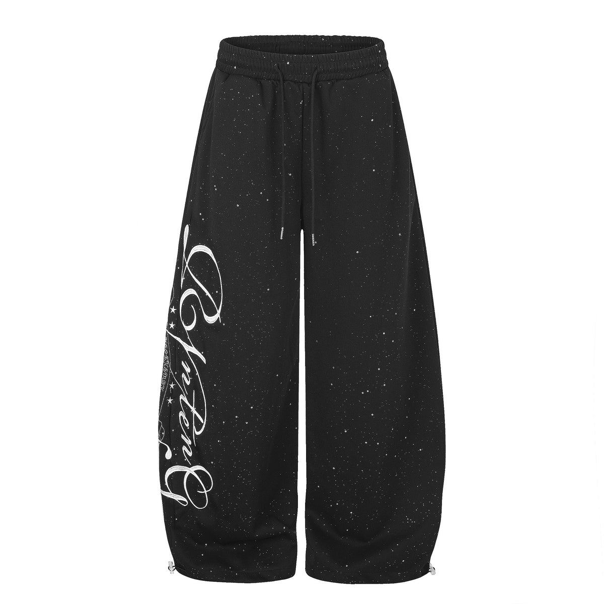 Black wide-leg sweatpants featuring white speckles and large cursive script on the left leg.