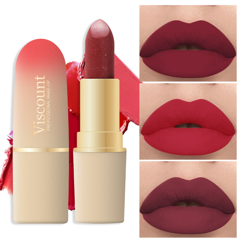 Red glitter lipstick in a gold tube with nude cap, shown with three lip color swatches on the right.