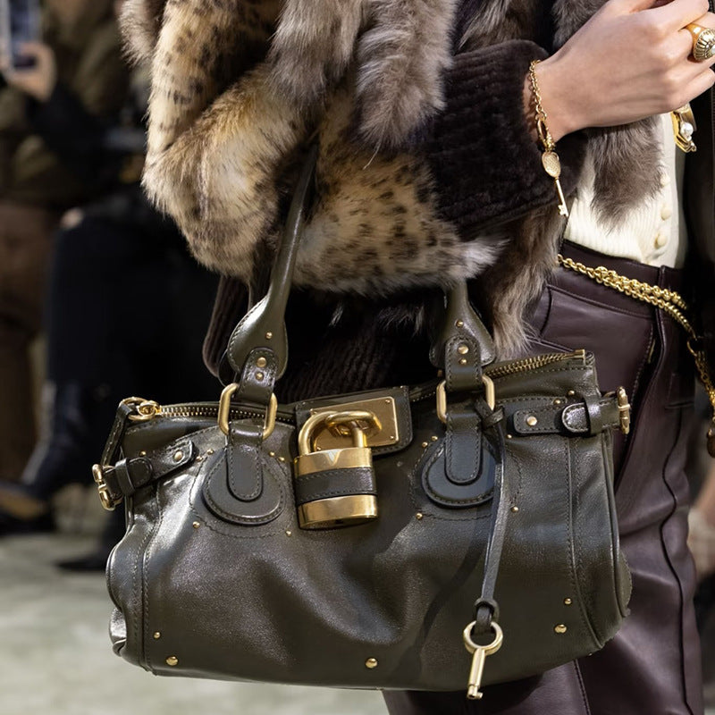 Vintage distressed padlock crossbody bag for women with handheld design, by Plush Fashion Hub, featuring a stylish, functional accessory.