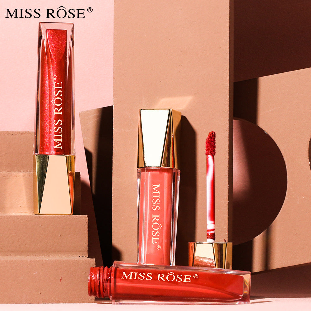 Miss Rose liquid lipsticks in clear plastic tubes with gold caps, showing red and pink shades.