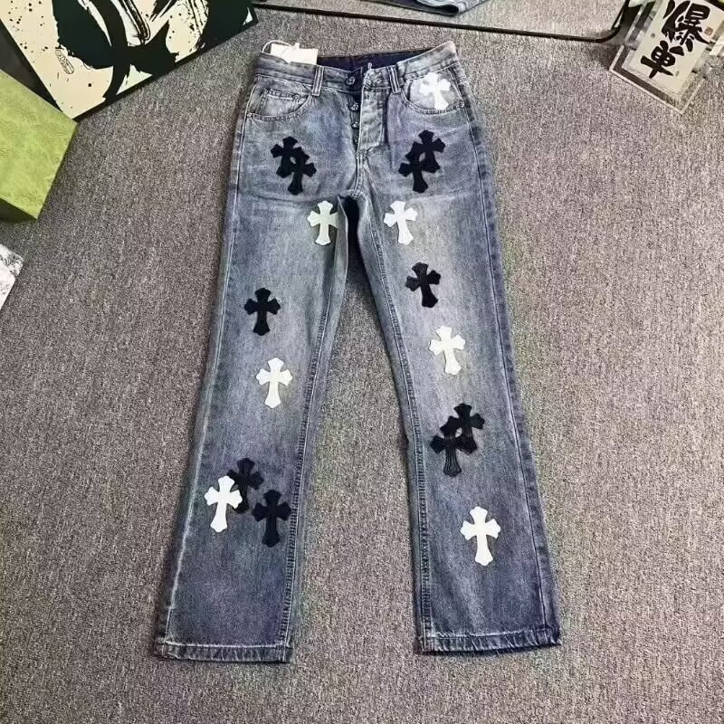 Blue denim jeans featuring a straight-leg style, embellished with white and black cross patches.