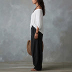 Women's one-shoulder t-shirt and wide-leg pants two-piece set by FitiqueFit, casual urban outfit, black fabric, stylish and comfortable.