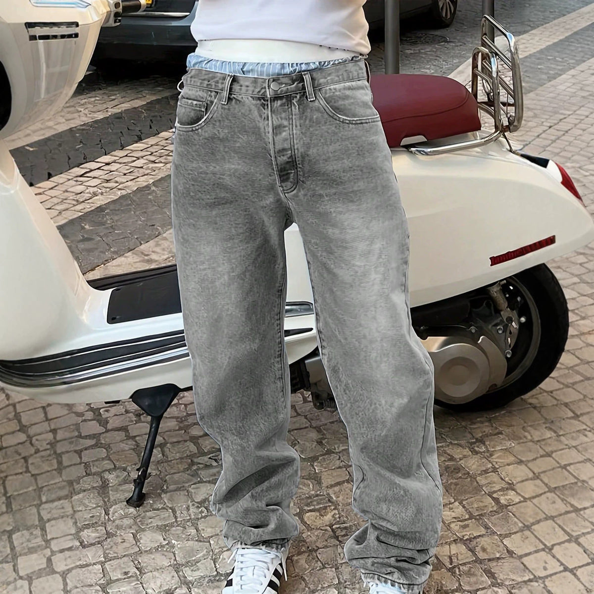 Acid-wash grey denim jeans with a relaxed straight-leg style, belt loops, and classic five-pocket construction.