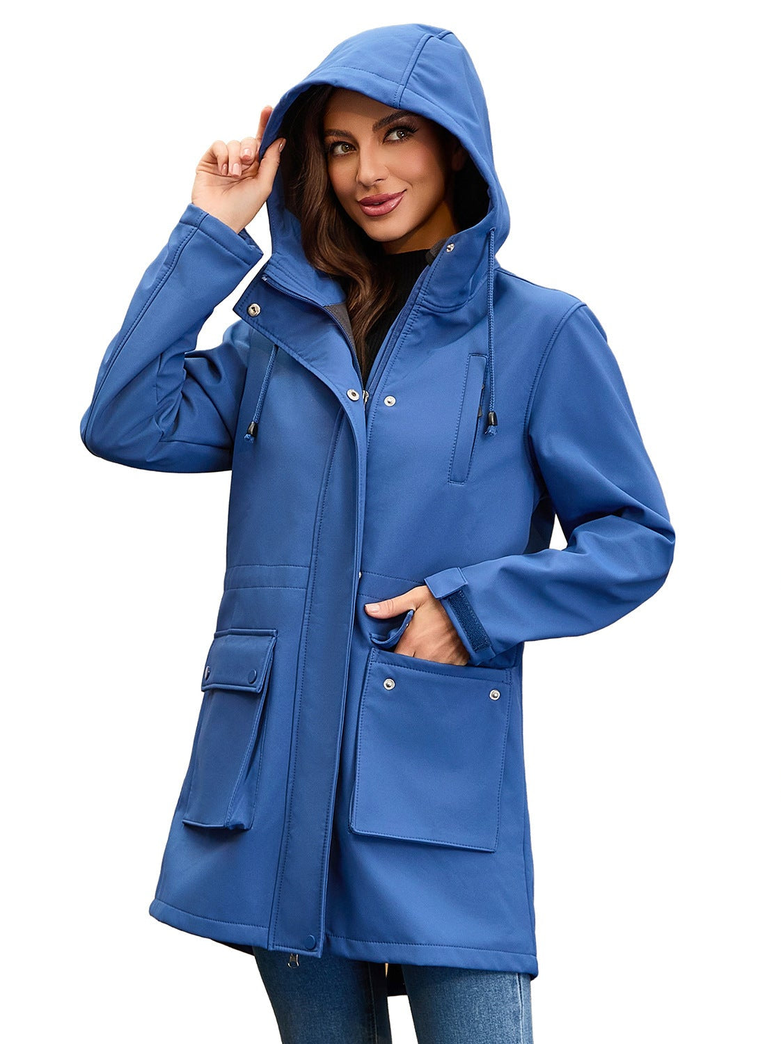 Woman wearing a solid blue hooded rain jacket with snap buttons, front pockets, and a drawstring hood.