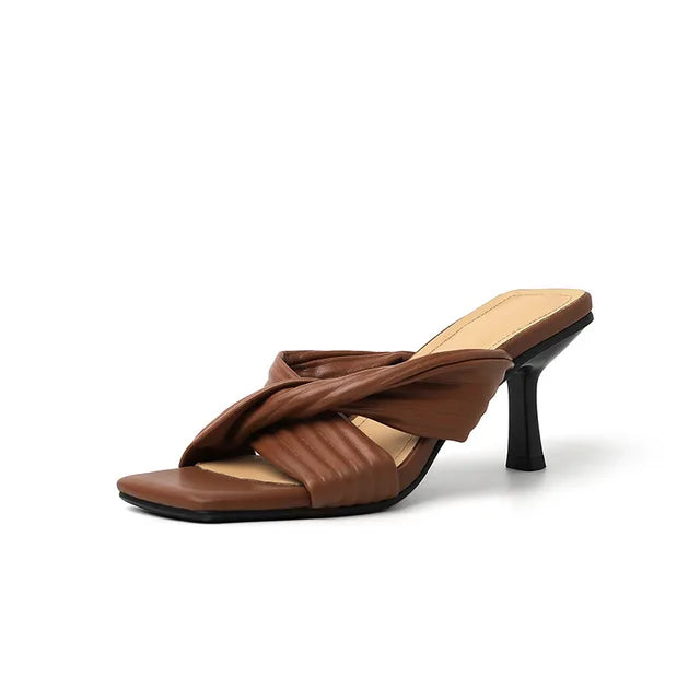 Elegant square-toe stiletto heels with crisscross straps by eprolo, showcasing a stylish design and sleek silhouette.