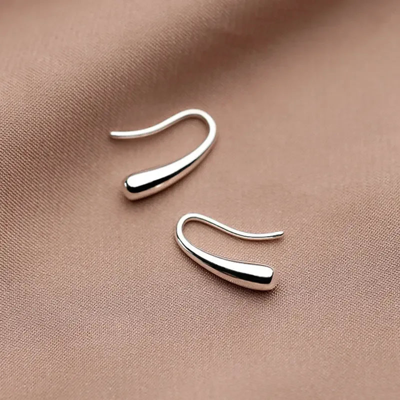 Elegant minimalist drop earrings in lightweight sterling silver jewelry for women, featuring simple, sleek design.