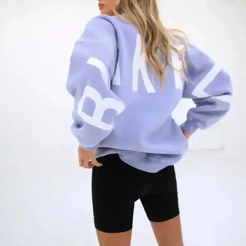 Oversized graphic print long sleeve sweatshirt by Plush Fashion Hub, cozy urban pullover with bold printed design and relaxed fit.