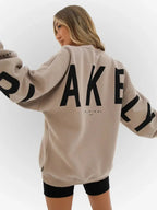 Oversized graphic print long sleeve sweatshirt from Plush Fashion Hub, featuring a cozy urban design and relaxed fit.