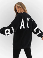 Oversized graphic print long sleeve sweatshirt by Plush Fashion Hub, cozy urban pullover with a bold urban print design.