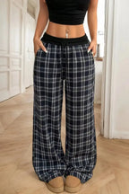 Women's high-waisted plaid flannel wide-leg pants from Plush Fashion Hub, featuring a cozy plaid pattern and relaxed fit.