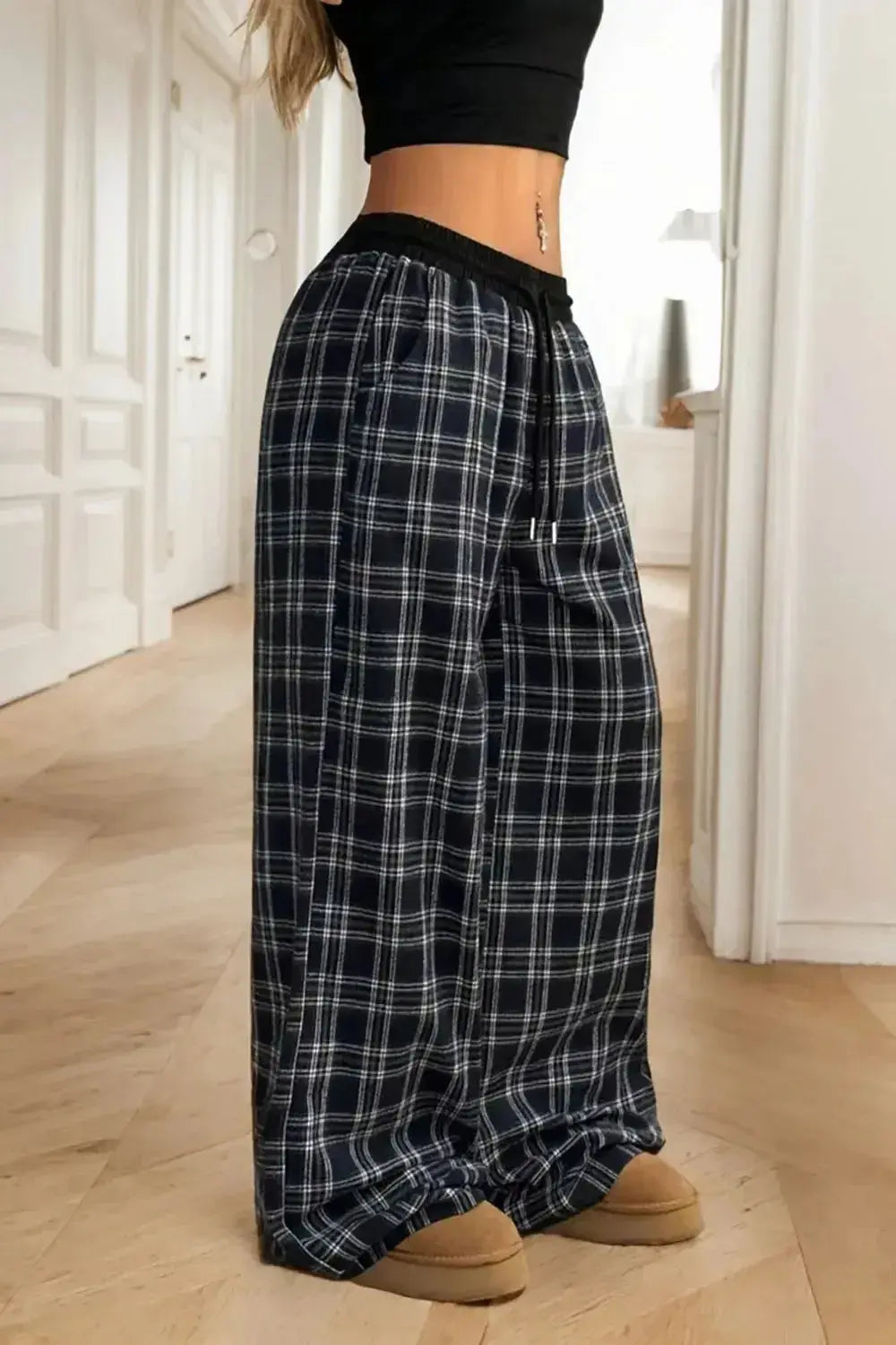 Women's high-waisted plaid flannel wide-leg pants by Plush Fashion Hub, featuring a comfortable relaxed fit and classic plaid pattern.