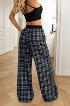 Women's high-waisted plaid flannel wide-leg pants by Plush Fashion Hub, shown in a cozy plaid pattern and relaxed fit.