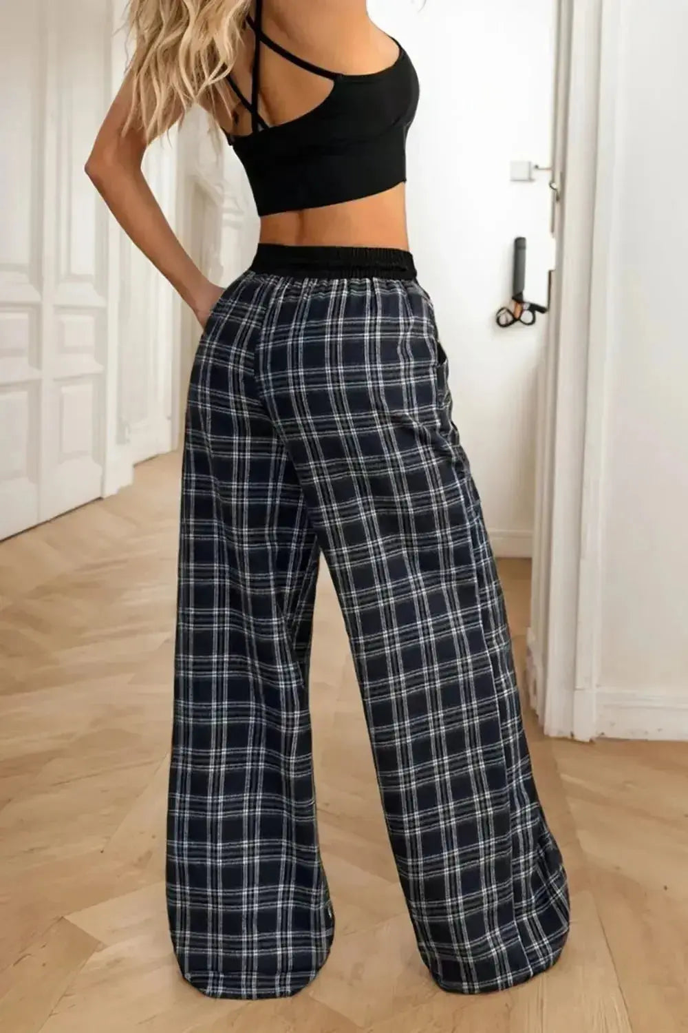 Women's high-waisted plaid flannel wide-leg pants by Plush Fashion Hub, shown in a cozy plaid pattern and relaxed fit.
