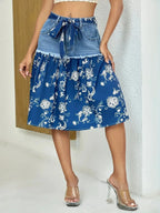 Floral print tiered denim skirt with frayed hem from Trendsi, showcasing colorful floral patterns and layered denim design.