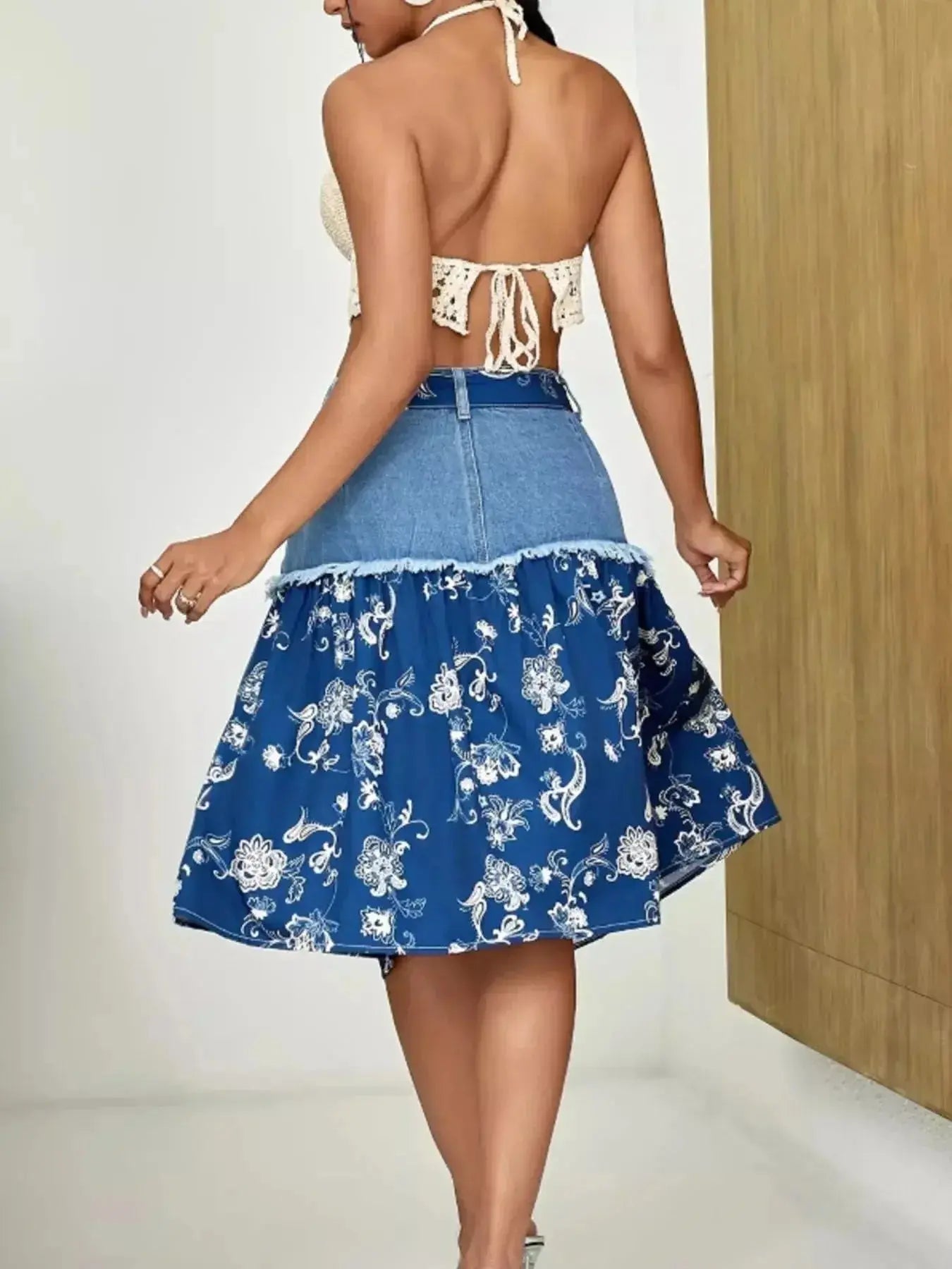 Floral print tiered denim skirt with frayed hem by Trendsi, showcasing a stylish layered design and casual denim fabric.