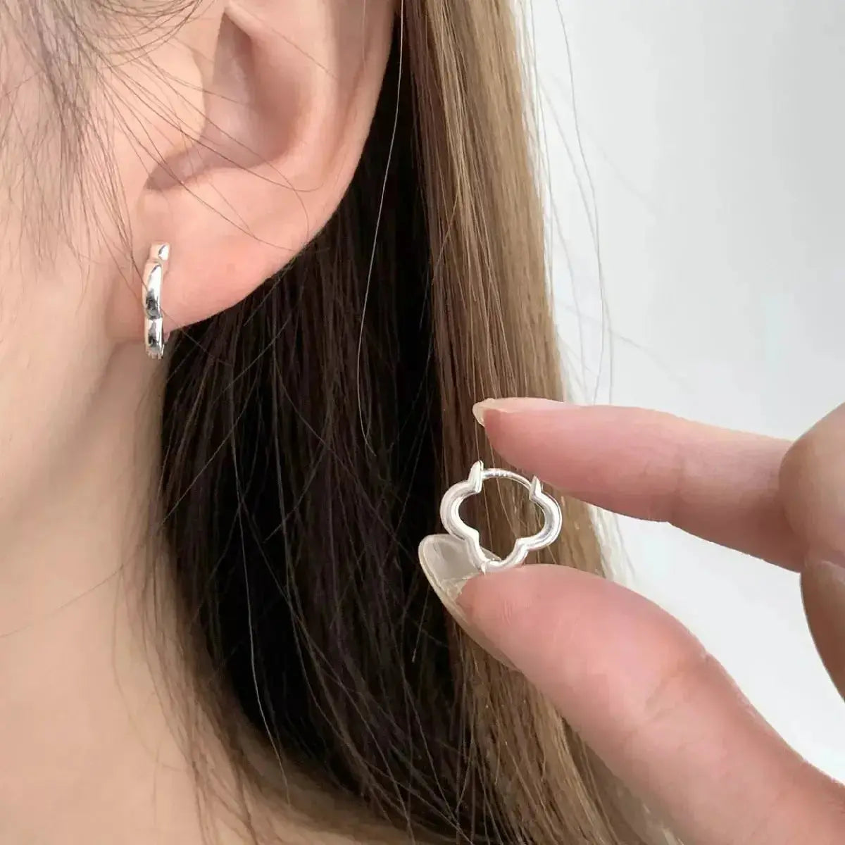 Sterling silver four-leaf clover stud earrings featuring detailed lucky clover design, perfect for elegant jewelry collection.