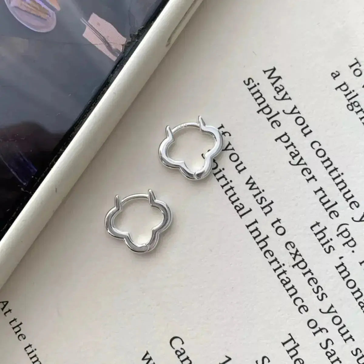 Sterling silver four-leaf clover stud earrings featuring detailed lucky clover jewelry design.