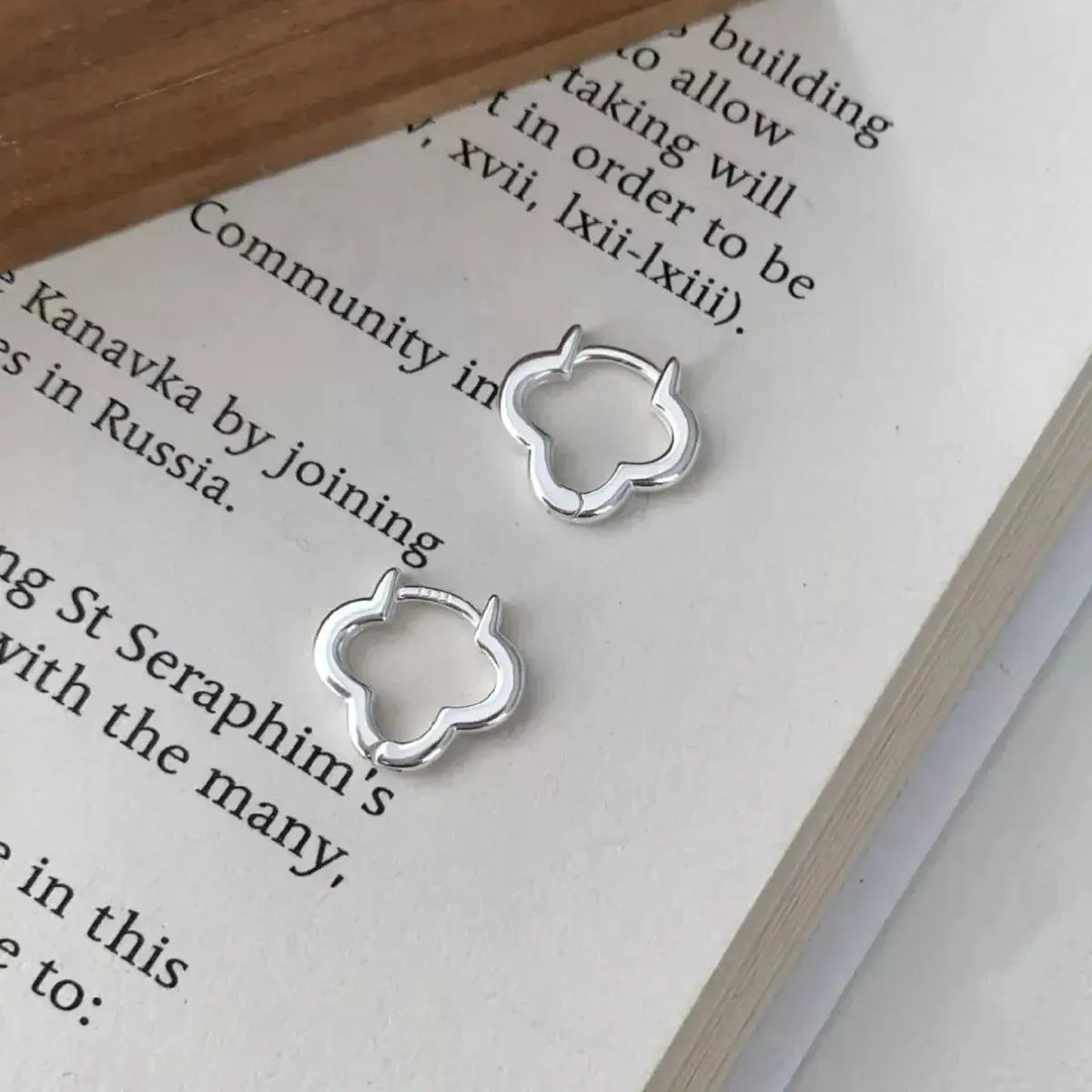 Sterling silver four-leaf clover stud earrings featuring detailed leaf design, perfect for lucky jewelry accessories.
