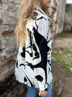 Plus size women's abstract print long sleeve button-up shirt by Plush Fashion Hub, featuring a stretch fit and stylish design.