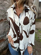 Plus size women's abstract print long sleeve button-up shirt by Plush Fashion Hub, featuring a stylish stretch fit design.