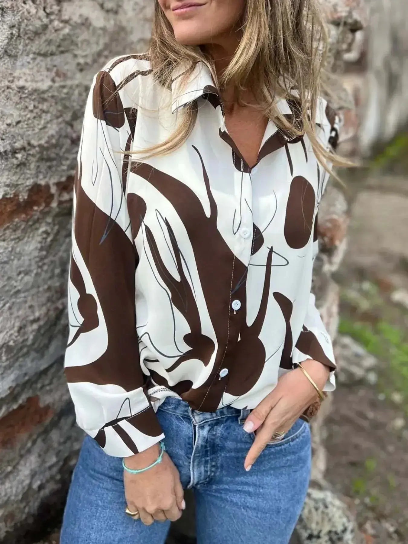 Plus size women's abstract print long sleeve button-up shirt by Plush Fashion Hub, featuring a stretch fit and vibrant design.