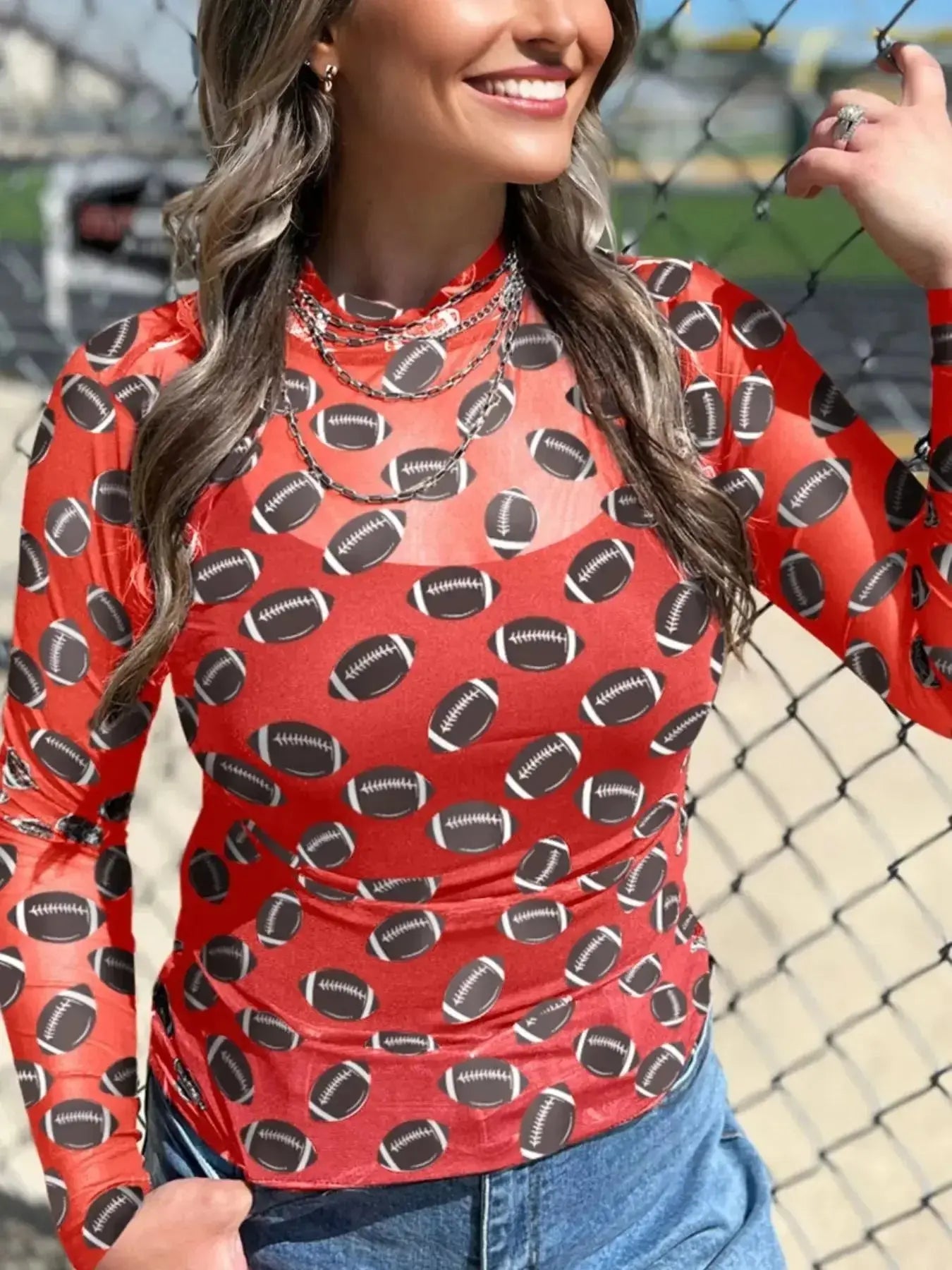 Black sheer mesh long sleeve top by Plush Fashion Hub featuring breathable stretch fabric, perfect for layering on game day.