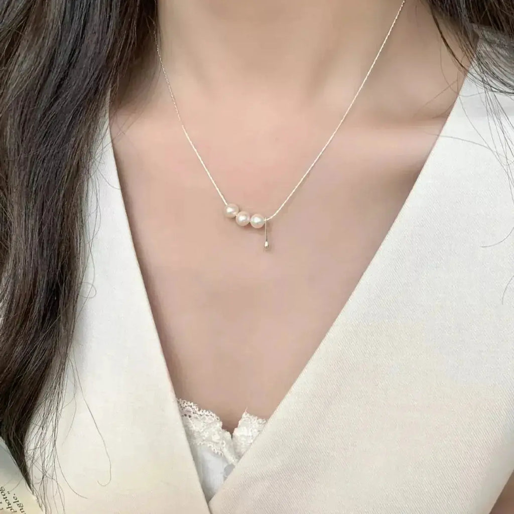 Genuine freshwater pearl pendant necklace with sterling silver chain, featuring a elegant silver and pearl design.
