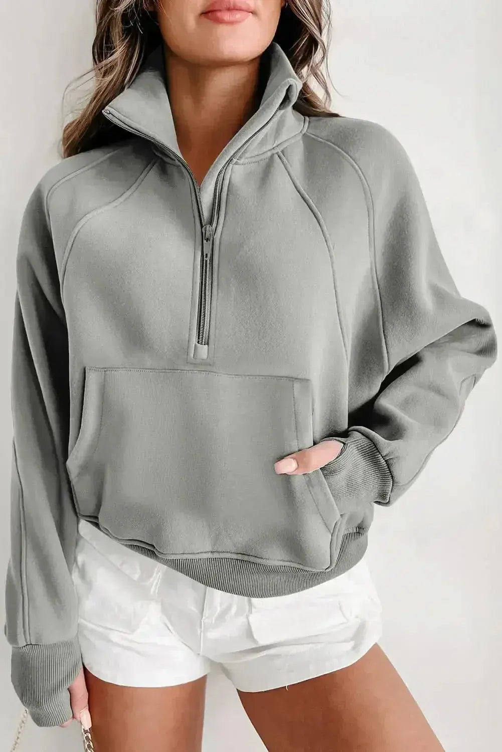 Green ribbed zip stand-collar sweatshirt for women with thumbhole sleeves, styled by Gilded Glamour Shop.
