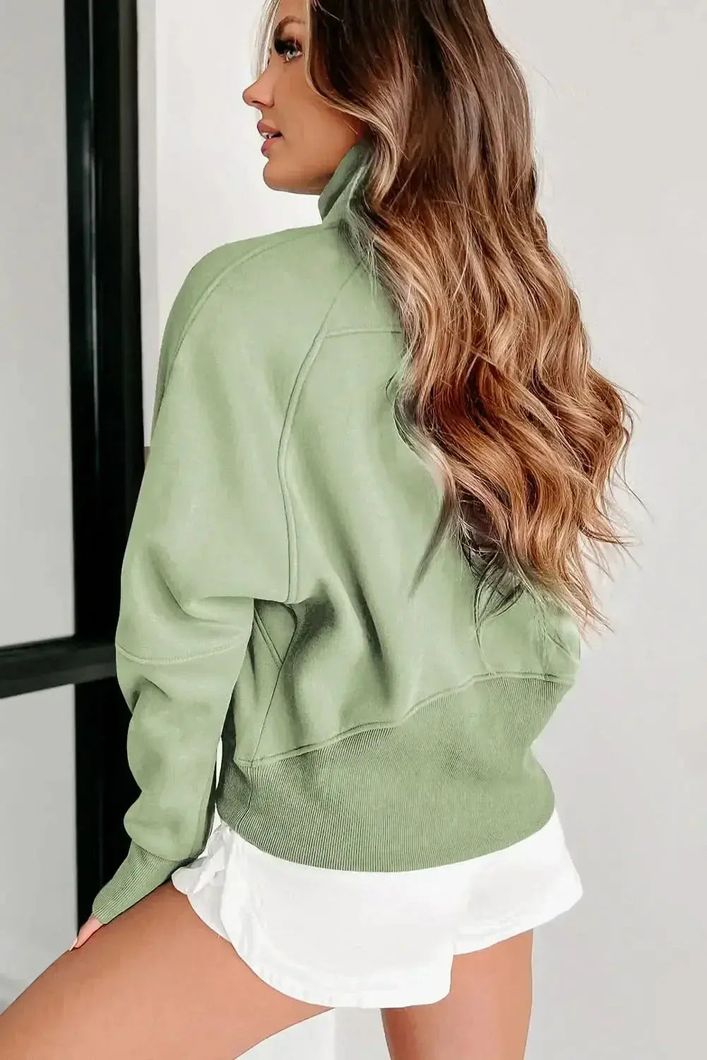 Women's green ribbed zip-up sweatshirt with stand collar and thumbhole sleeves, by Gilded Glamour Shop.