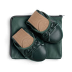 Green Talaria Flats footwear, premium evergreen flats folded on a bag, showcasing their stylish and comfortable design.