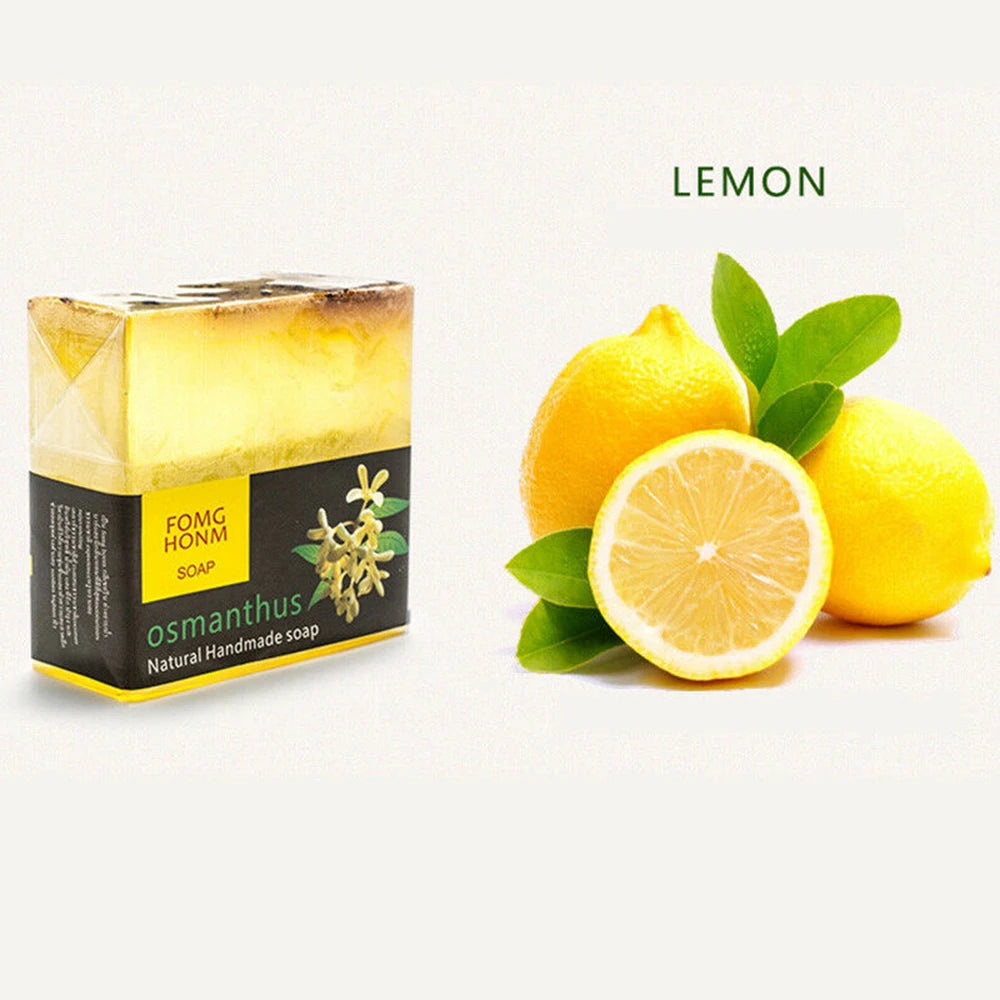 Yellow osmanthus natural handmade soap bar in packaging beside whole and halved lemons.