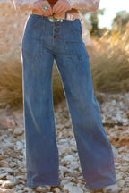 High-waisted wide-leg denim jeans with button front by Plush Fashion Hub, showcasing classic blue fabric and relaxed fit.