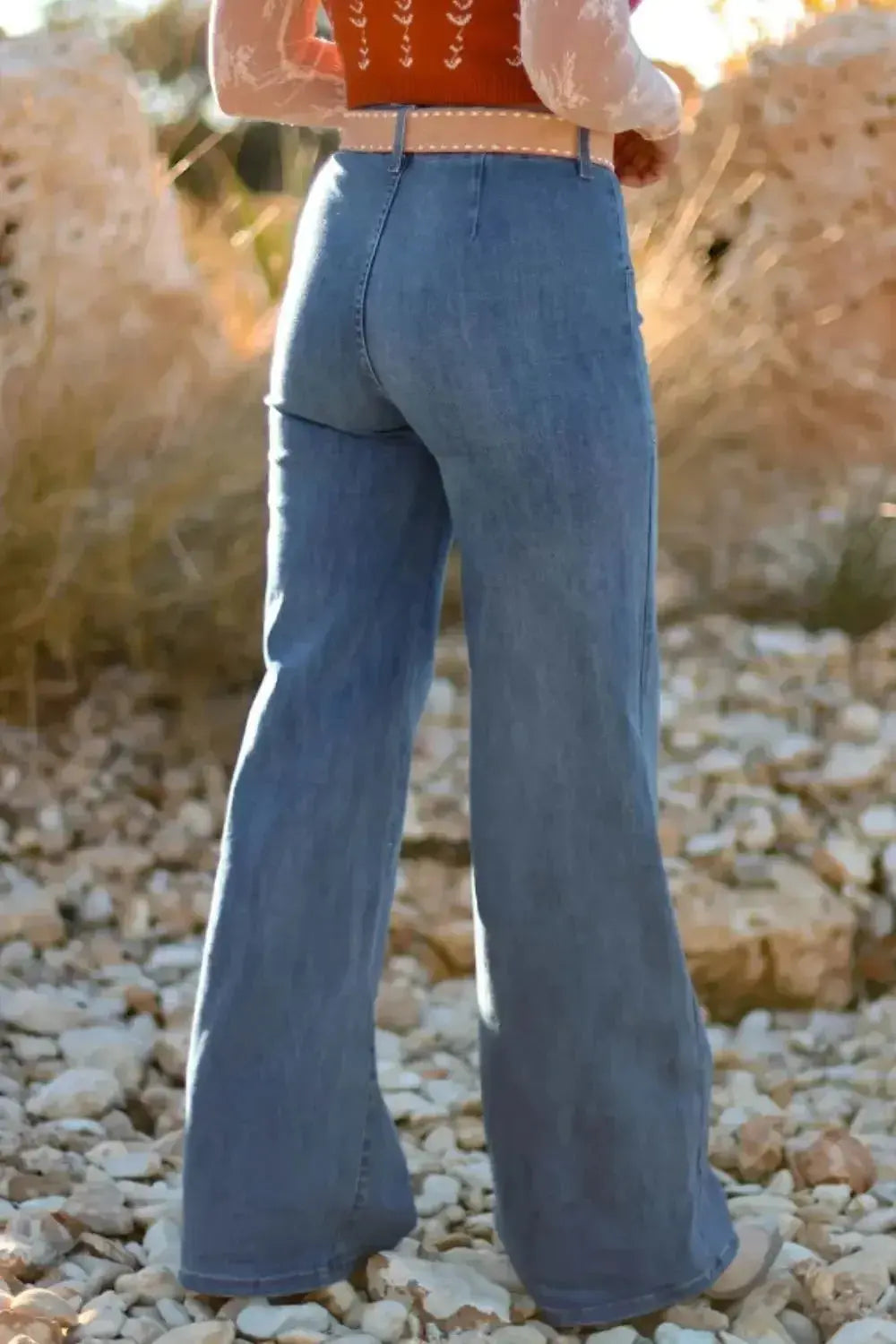 High-waisted wide-leg denim jeans with button front from Plush Fashion Hub, styled with casual top and belt on a model.
