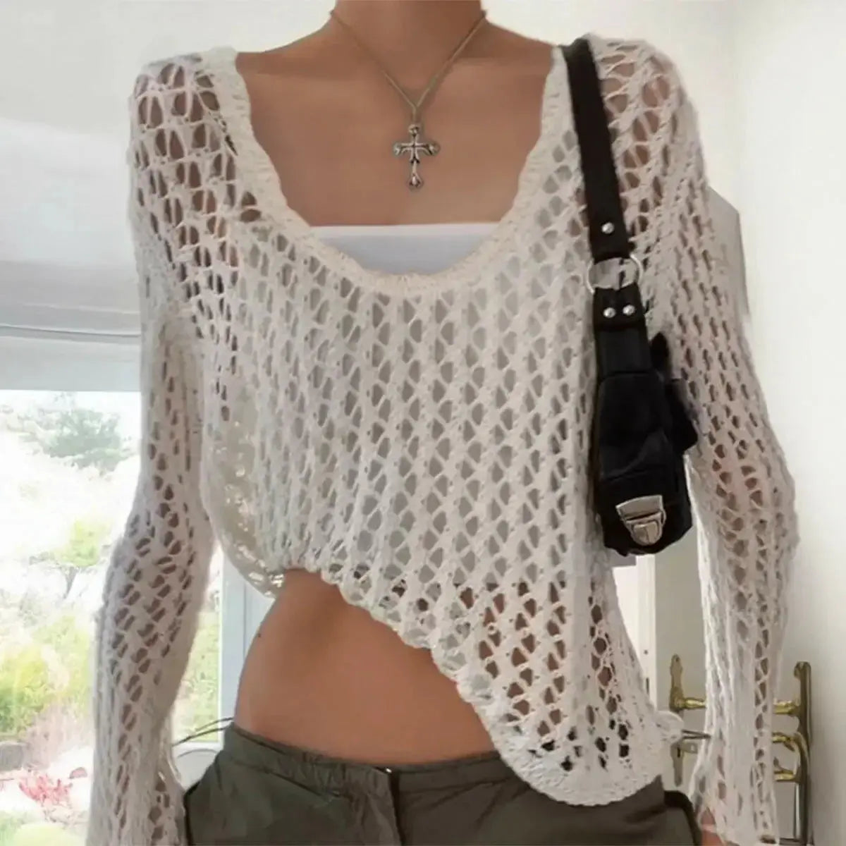 Trendy women's hollow-out long sleeve top by Plush Fashion Hub, lightweight casual pullover with stylish cut-out design.