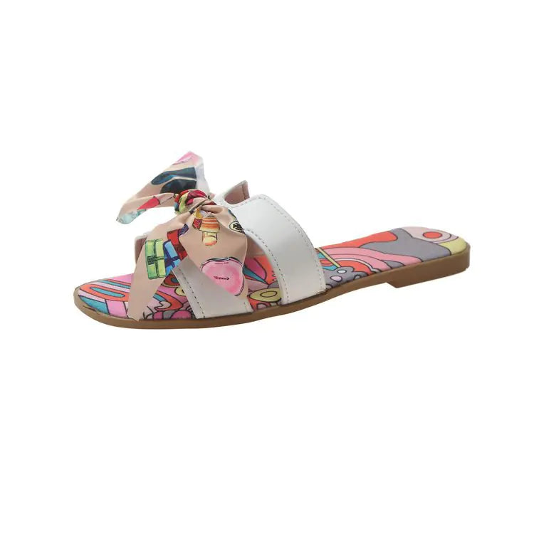 Women's flat summer slippers with bow detail from Trendy Attic Store01, featuring a comfortable sandal design with stylish accents.